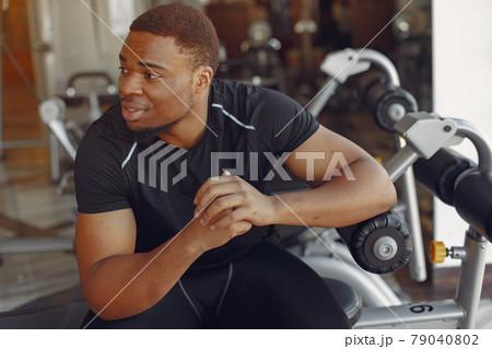 A handsome black man is engaged in a gym A handsome black man is engaged in a gym 79040802