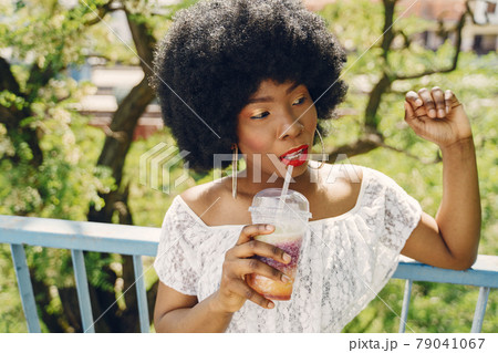 Portrait beautiful smiling african woman in city closeup Portrait beautiful smiling african woman in city closeup 79041067