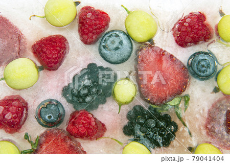 different juicy berries frozen in ice. useful vitamin healthy food different juicy berries frozen in ice. useful vitamin healthy food 79041404