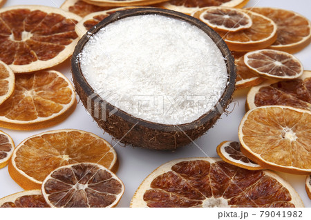 coconut with nut chips on a background of dried citrus fruits coconut with nut chips on a background of dried citrus fruits 79041982