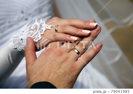 hands of the bride and groom together hands of the bride and groom together 79041985