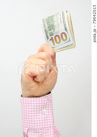 Male hand holds dollar banknotes on a white background 79042015