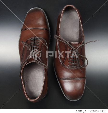 Classic men's brown Oxford shoes on dark background 79042612