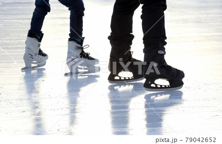feet skating people ice skating on the ice rink. 79042652