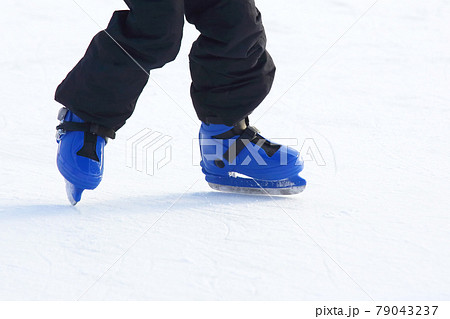 legs in blue skating on the ice rink legs in blue skating on the ice rink 79043237