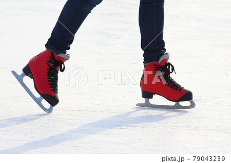 feet in red skates on an ice rink feet in red skates on an ice rink 79043239