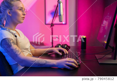 Focused Beautiful Blonde Gamer Girl Playing Online Video Game on Her Personal Computer. Focused Beautiful Blonde Gamer Girl Playing Online Video Game on Her Personal Computer. 79045812