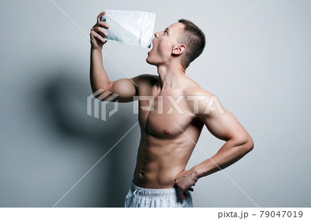 bodybuilder eating sports nutrition. Sport body muscular Man bodybuilder eating sports nutrition. Sport body muscular Man 79047019
