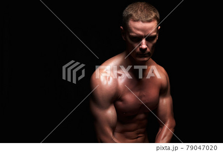 bodybuilder in dark. strong Boy. Naked body muscular Man bodybuilder in dark. strong Boy. Naked body muscular Man 79047020