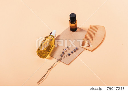 Natural hair care cosmetics, lavender oil, dry herbs and wooden comb 79047253