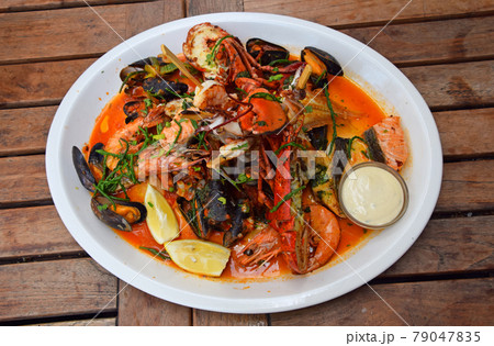 Grilled seafood platter on wooden table 79047835