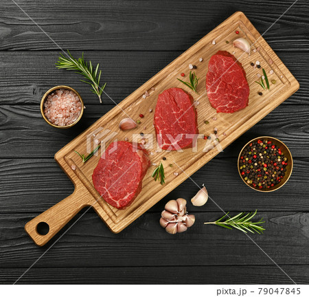 Close up raw beef tenderloin steak on board 79047845
