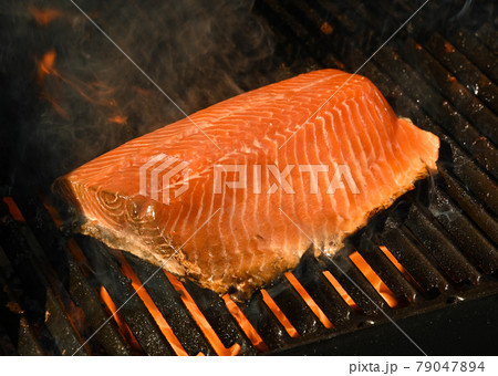 Searing and smoking salmon fish fillet on grill Searing and smoking salmon fish fillet on grill 79047894