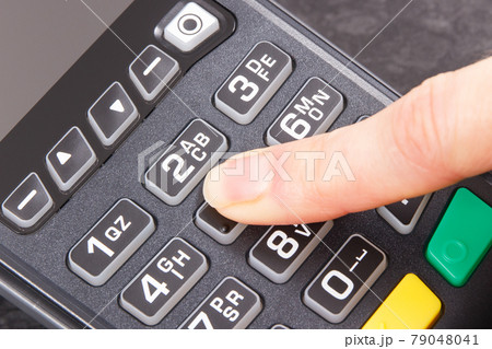 Payment terminal and finger entering PIN code. Credit card reader using for cashless paying 79048041
