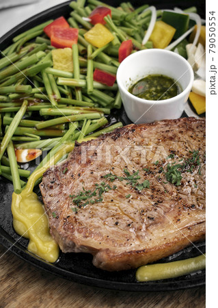 organic tenderloin beef steak sizzler on hot plate meal platter 79050554