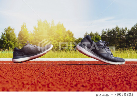 Sport shoes on racetrack 79050803