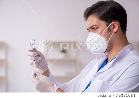 Young male doctor in vaccination concept Young male doctor in vaccination concept 79051031