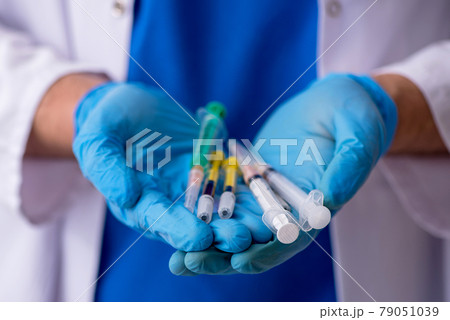 Young male doctor in vaccination concept 79051039