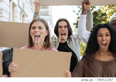 Closeup of furious multiracial protestors with empty placards 79052297