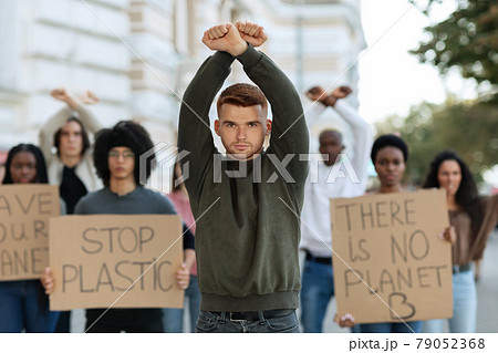 Caucasian guy leader leading international group of protestors 79052368