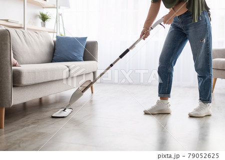 Portrait of muslim woman cleaning floor with spray mop Portrait of muslim woman cleaning floor with spray mop 79052625