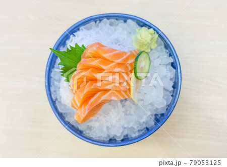 Salmon sashimi on ice serve with fresh wasabi and carrot slide, Japanese food style. Top view with copy space and text Salmon sashimi on ice serve with fresh wasabi and carrot slide, Japanese food style. Top view with copy space and text 79053125