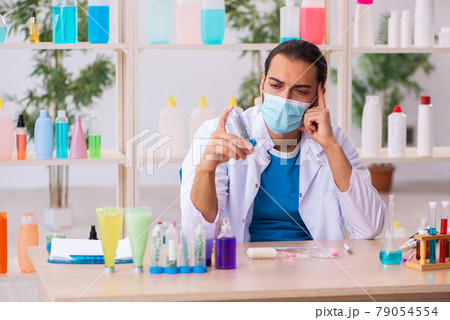 Young male chemist testing soap in the lab Young male chemist testing soap in the lab 79054554