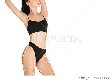 Beautiful slim female body in black underwear isolated over light background. 79057355
