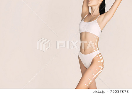 Cropped slim female body in white underwear isolated over light background. 79057378