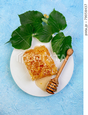 Lime honey in honeycombs. 79058437