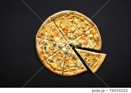 Pizza with cheese feta parmesan mozzarella dor blu on a black stone background 79059203