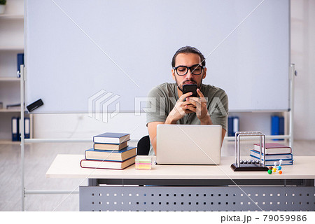 Young male student preparing for exams in the classroom 79059986