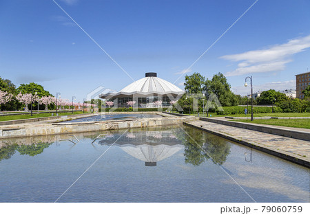 View over the Moscow State Circus  on Vernadskogo Prospekt with blooming spring trees, sunny day, Russia 79060759