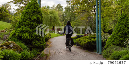 Adventure Woman Bike Riding in a Park Adventure Woman Bike Riding in a Park 79061637