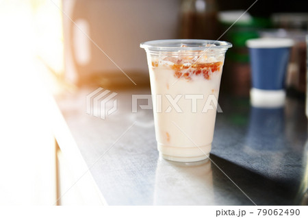 Ice coffee with caramel sauce in a takeaway cup on a bar counter Ice coffee with caramel sauce in a takeaway cup on a bar counter 79062490