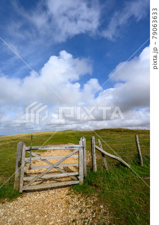 South Downs National Park, Sussex, UK near Firle Beacon. A gate and fence on the route of the South Downs Way. The South Downs Way is a national trail popular with walkers. South Downs National Park, Sussex, UK near Firle Beacon. A gate and fence on the route of the South Downs Way. The South Downs Way is a national trail popular with walkers. 79063633