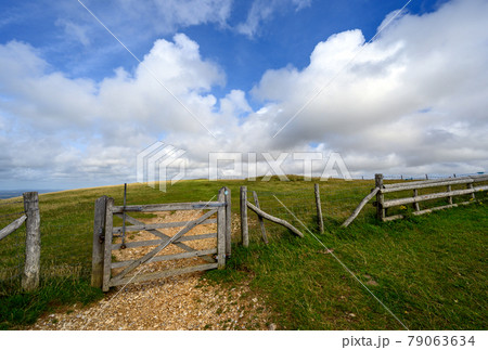 South Downs National Park, Sussex, UK near Firle Beacon. A gate and fence on the route of the South Downs Way. The South Downs Way is a national trail popular with walkers. South Downs National Park, Sussex, UK near Firle Beacon. A gate and fence on the route of the South Downs Way. The South Downs Way is a national trail popular with walkers. 79063634