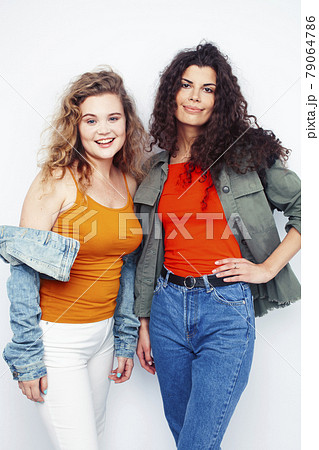 young pretty teenage girls friends with blond and brunette curly hairs posing cheerful isolated on white background, lifestyle people concept young pretty teenage girls friends with blond and brunette curly hairs posing cheerful isolated on white background, lifestyle people concept 79064786