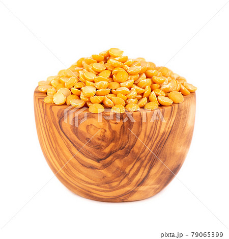 Dry yellow split peas in olive bowl, isolated on white background. Halves of yellow legume peas. Dry yellow split peas in olive bowl, isolated on white background. Halves of yellow legume peas. 79065399