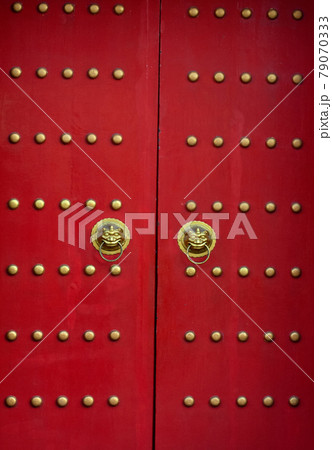 Red door with lion heads in asian style. Red door with lion heads in asian style. 79070333