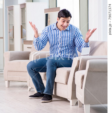 Young man shopping in furniture store 79071374