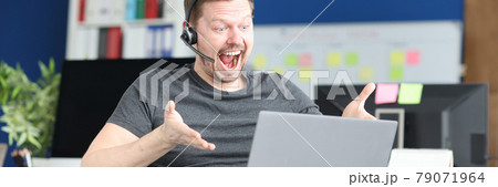 Man in wheelchair in headset communicating via laptop 79071964