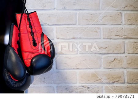 Boxing gloves black with orange on a brick wall background. Sport Concept  79073571