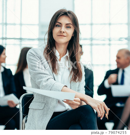 young business woman against the background of her colleagues. young business woman against the background of her colleagues. 79074255