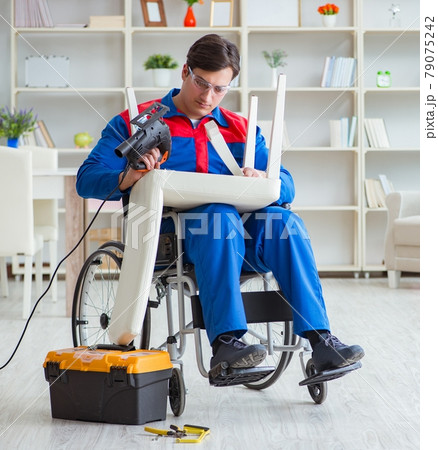 Disabled man repairing chair in workshop Disabled man repairing chair in workshop 79075242