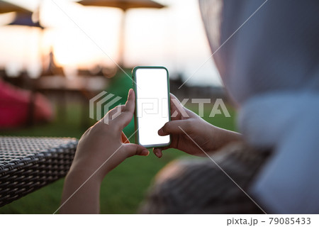 Cropped shot view of woman's hands holding smart phone with blank copy space screen 79085433