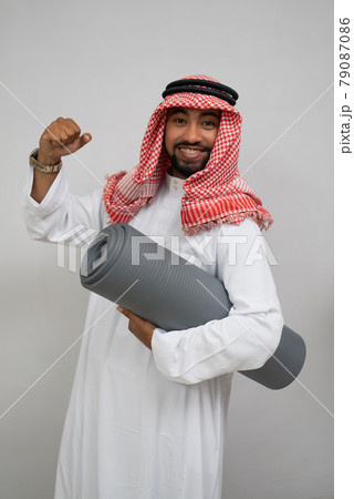 an arabian turban smiling excitedly while holding a roll of mattress and the other hand clenched up an arabian turban smiling excitedly while holding a roll of mattress and the other hand clenched up 79087086