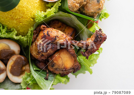 nasi tumpeng. indonesian cuisine yellow rice on banana leaf nasi tumpeng. indonesian cuisine yellow rice on banana leaf 79087089