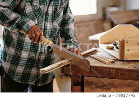 Carpenter Working with Japanese Saw 79087745