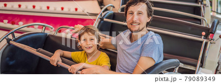 happy smiling son and his handsome father spending fun time together at amusement park BANNER, LONG FORMAT happy smiling son and his handsome father spending fun time together at amusement park BANNER, LONG FORMAT 79089349